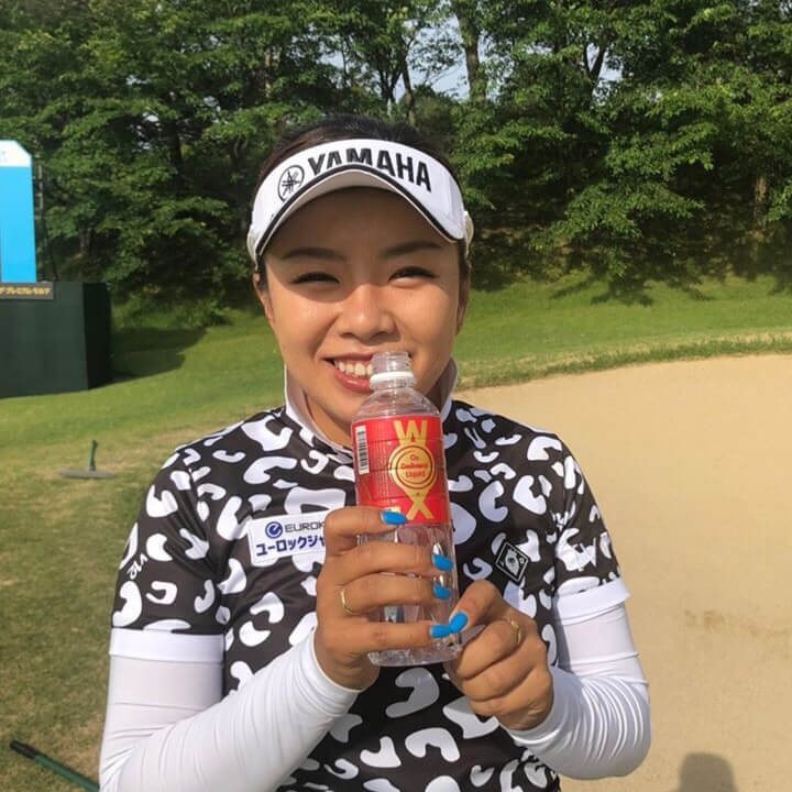 Professional golfer with a bottle of WOX