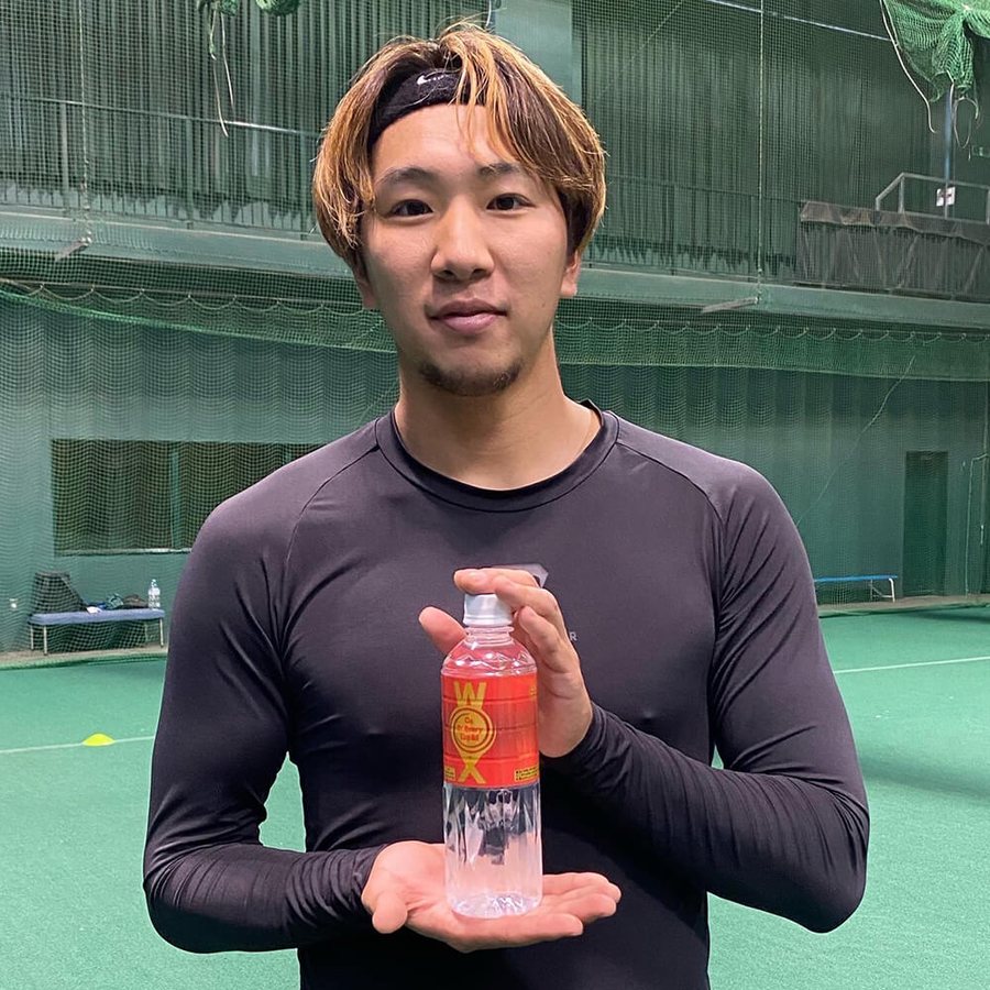 Athlete in training kit holding WOX